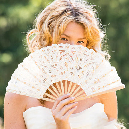 Bride holding a Antiqued Lace Hand Fan