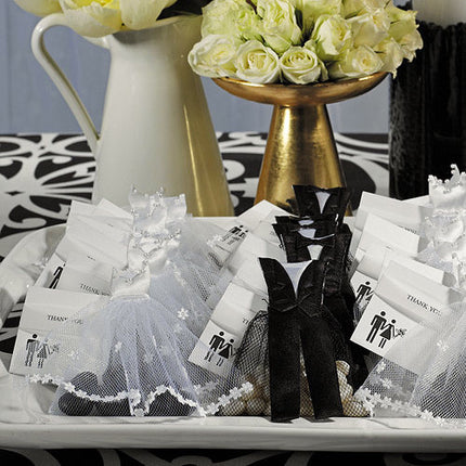 A beautiful display of the Groom & Bride Wedding Favor Candy Bags with yellow flowers.The bags are filled with candy and jelly beans.