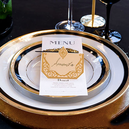 Art Deco Laser Embossed Place Card in gold and ivory a top of a wedding menu.
