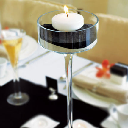 A small Floating Candles sitting in a glass centerpiece (not included).